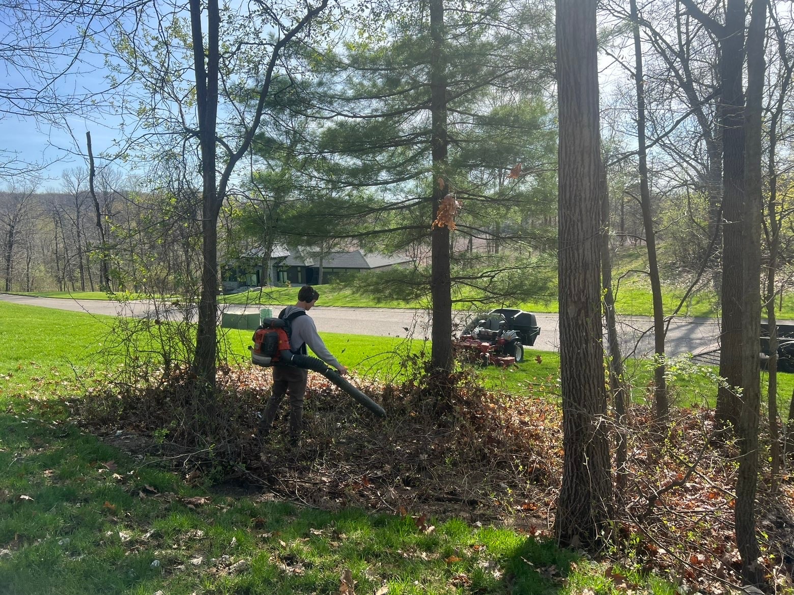 Bemis crew blowing leaves during spring cleanup