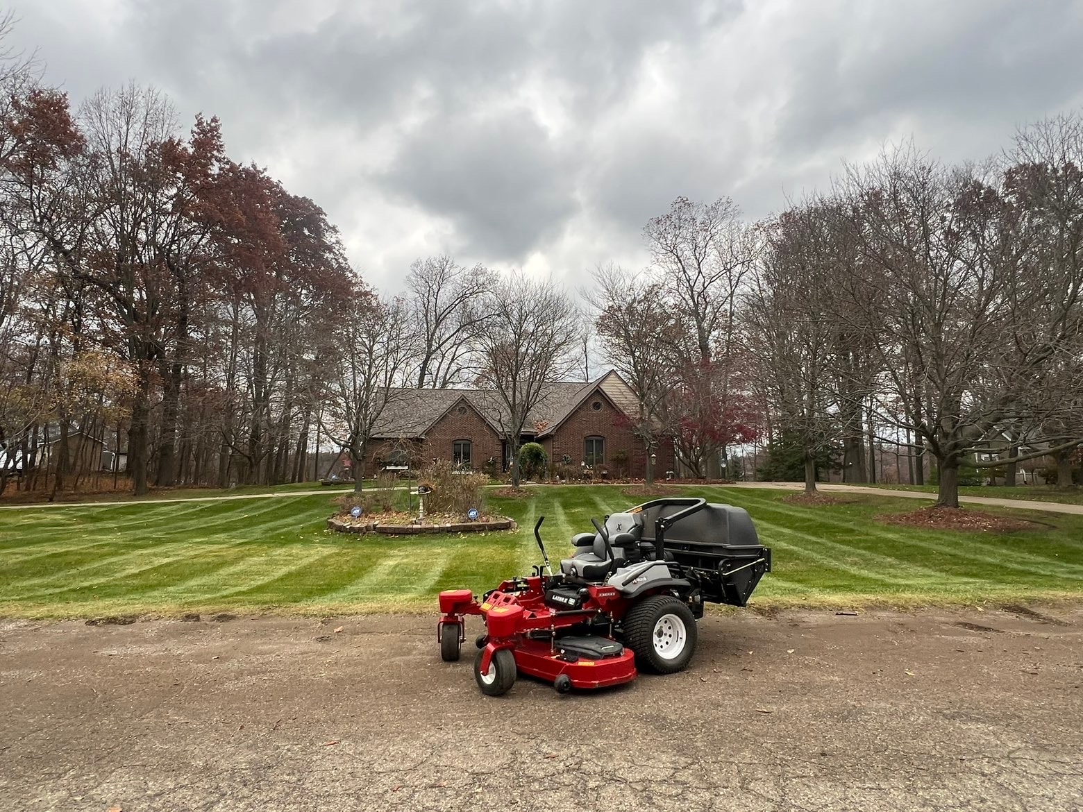 Zero-turn mower on striped lawn after fall cleanup — Bemis