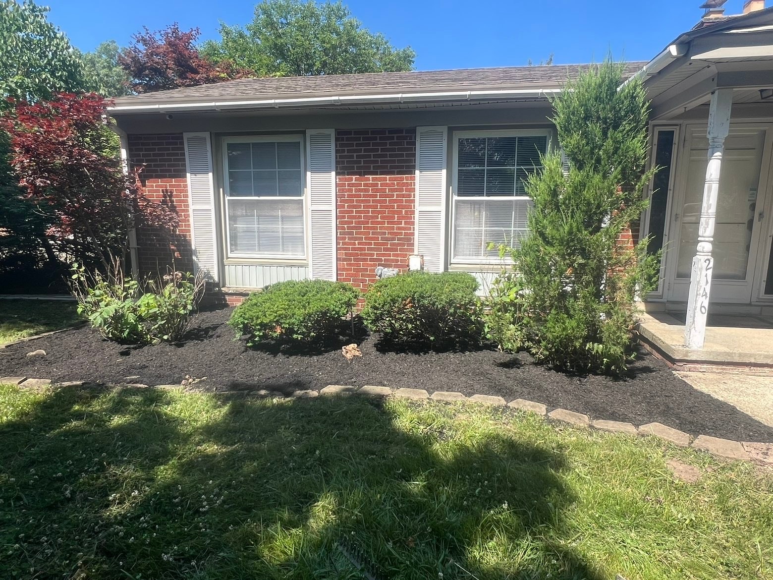 Residential home with manicured lawn and landscaping — Bemis